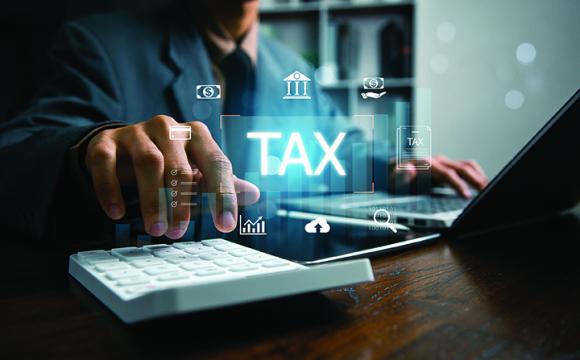 hand on keyboard with the word tax