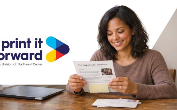 A woman looking at a piece of direct mail fundraising efforts