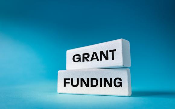 Text Grant Funding written on natural white elements on a beautiful blue background