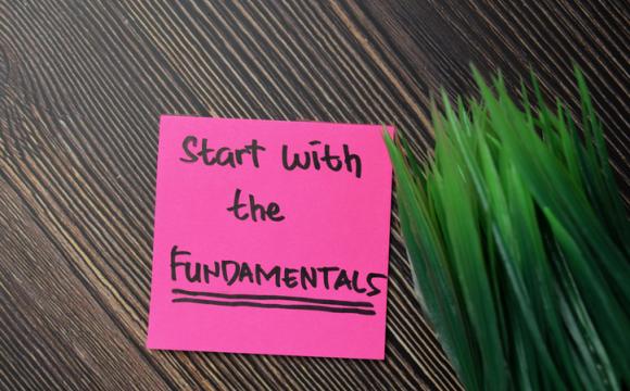 Start With The Fundamentals write on sticky notes isolated on office desk. stock photo
